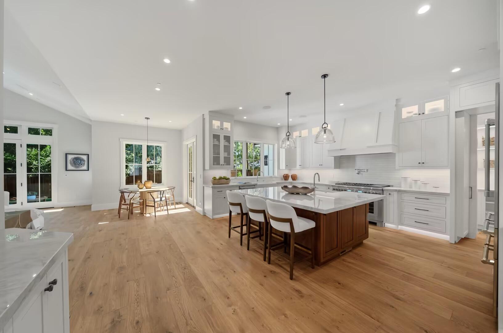 Bright open-plan kitchen with a timber island and white cabinetry