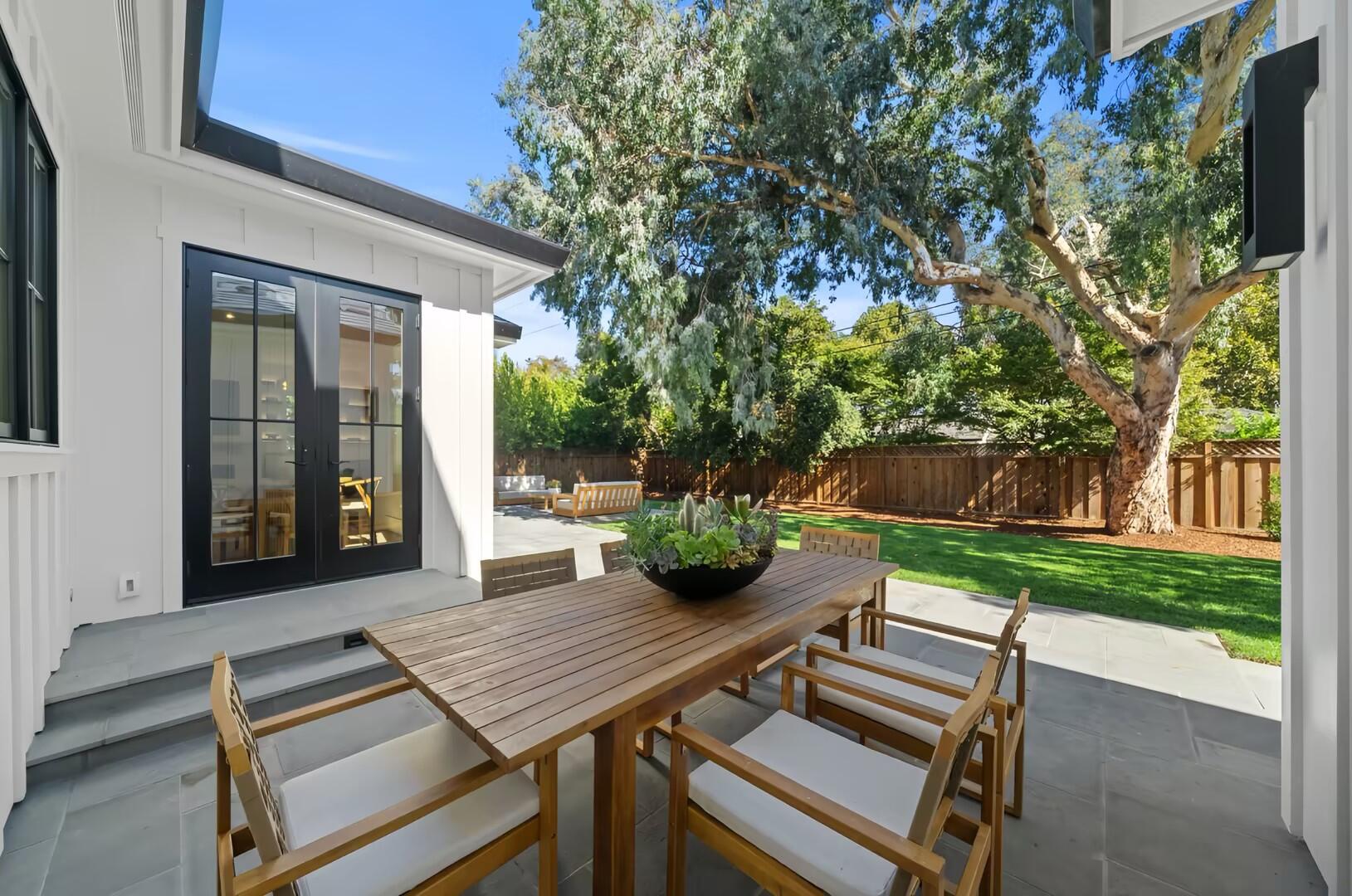 Outdoor dining patio overlooking the garden at a modern American villa