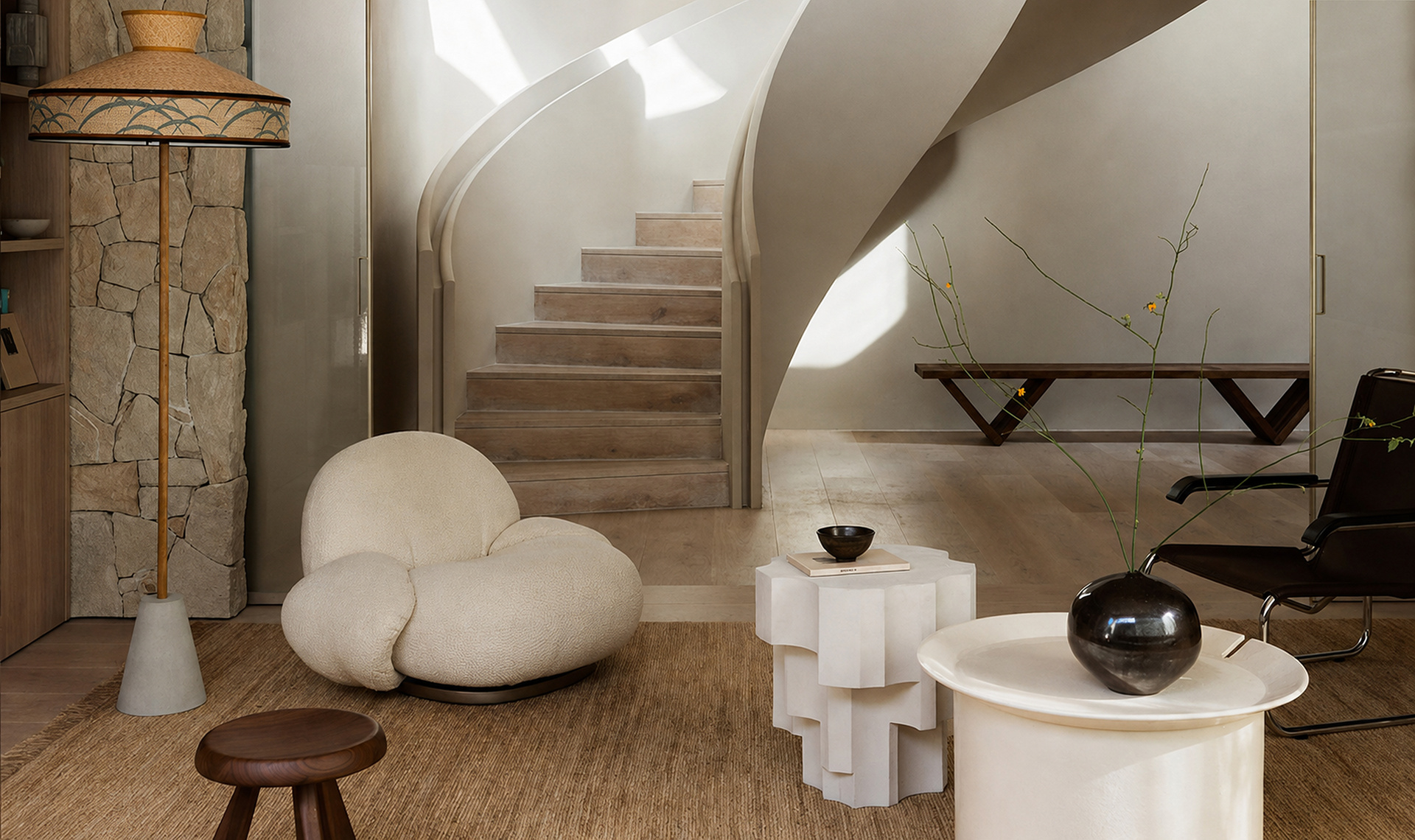 Sculptural stair lounge with curved architecture and collected furniture