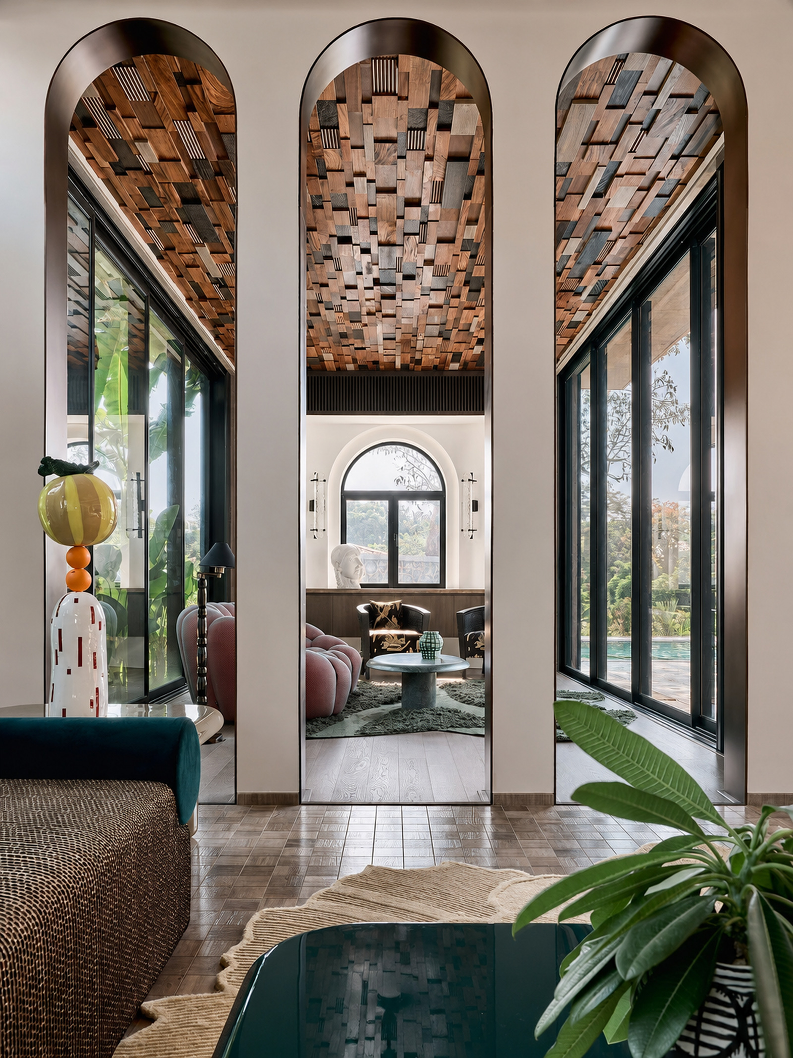 Arched interior lounge with a layered wood ceiling in a tropical modern Indian villa