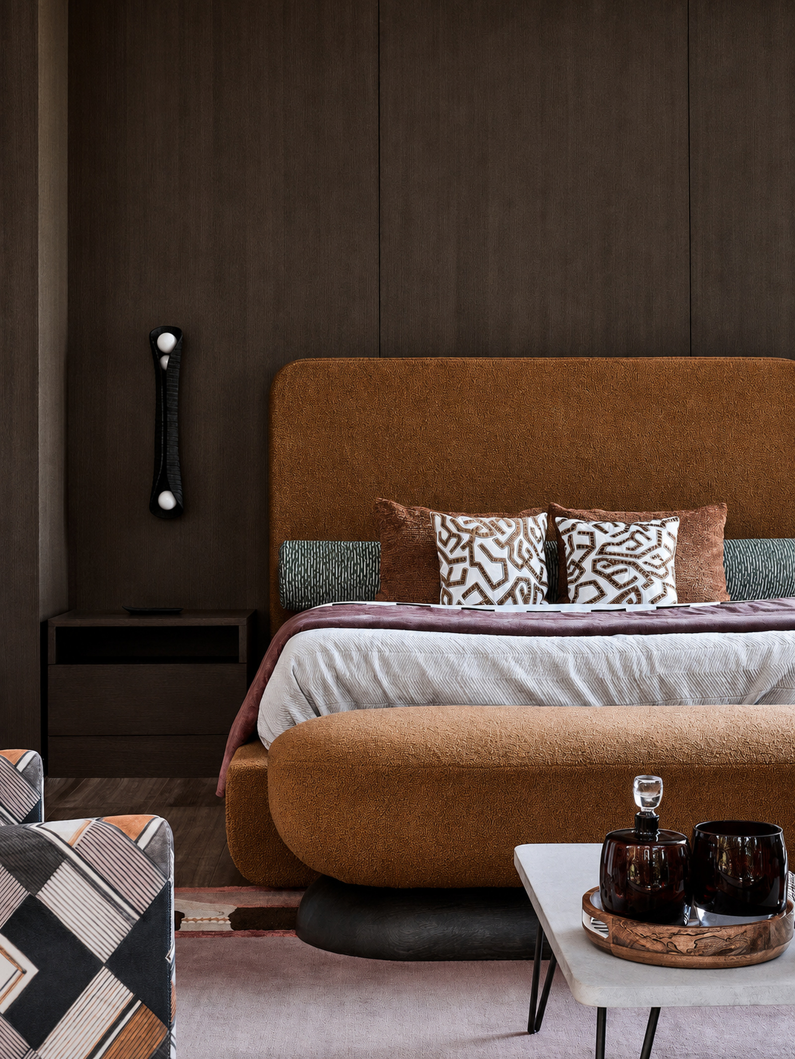 Warm modern bedroom with a sculptural upholstered bed in an Indian tropical villa