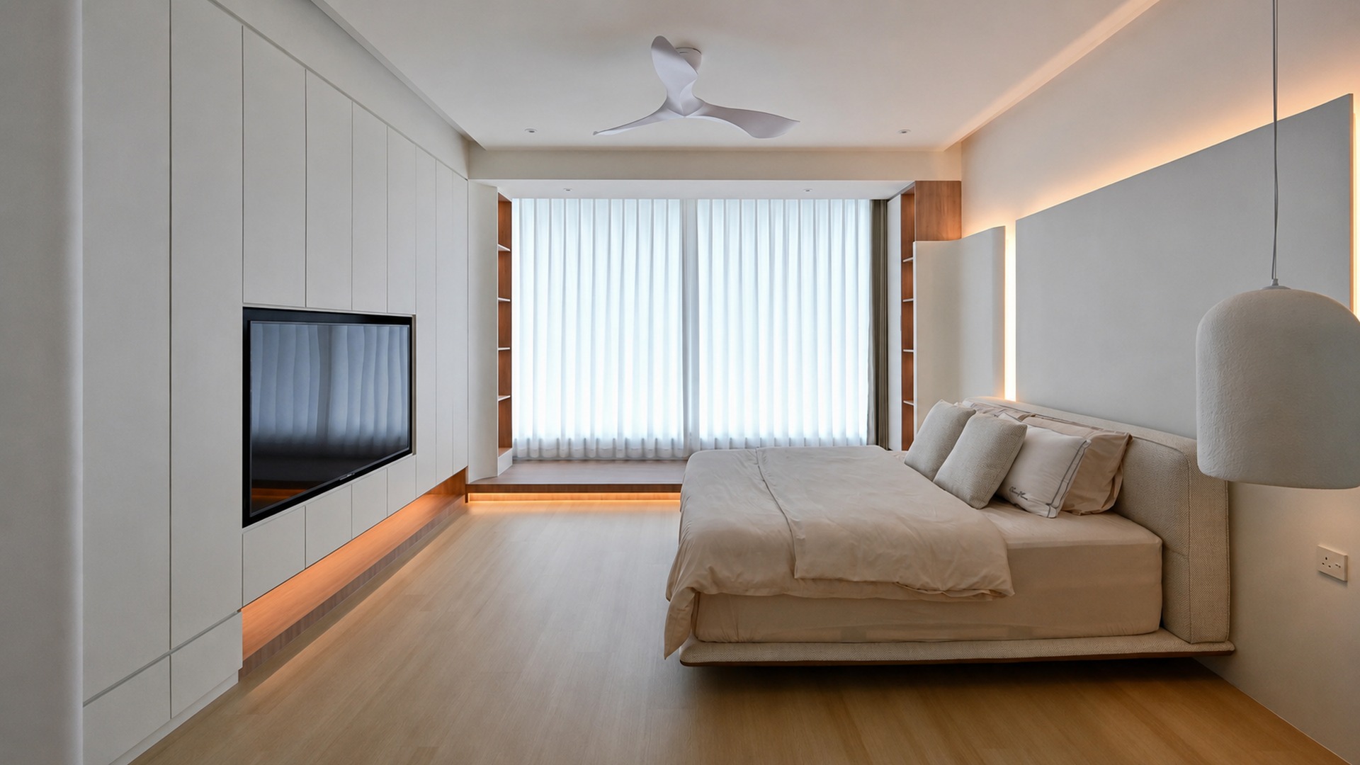 Calm neutral bedroom with integrated storage in a Malaysian villa